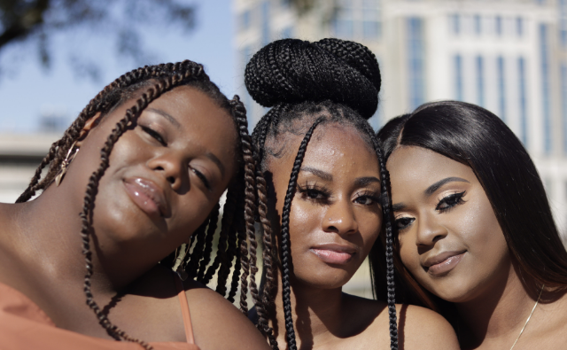 Black woman rocking different hairstyles ie. twist, braids, wig