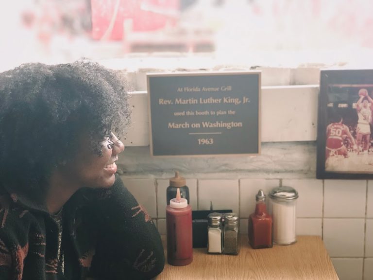 Kaylannk sitting at Florida Ave Grill's MLK March on Washington Booth