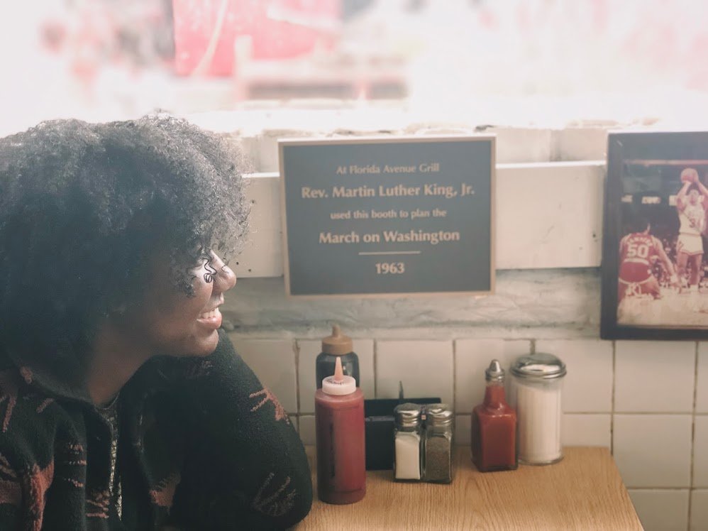 Kaylannk sitting at Florida Ave Grill's MLK March on Washington Booth