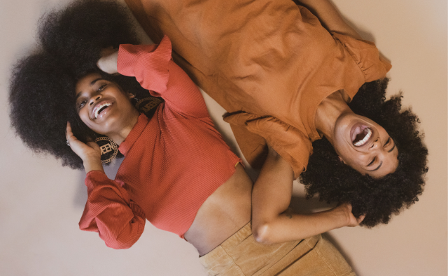 Black girls laughing and loving their natural hair
