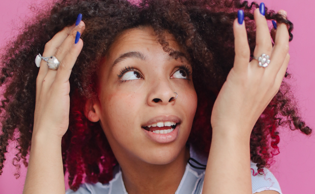 Black girl admiring her natural hair