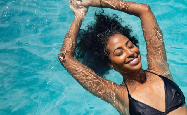 Black girl swimming and smiling