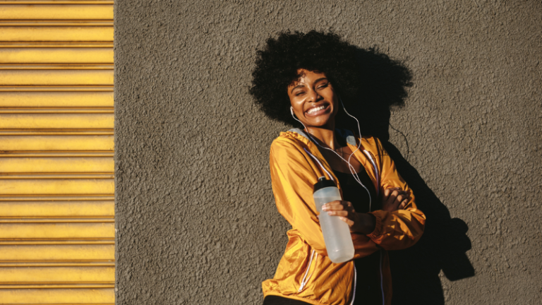 black woman wearing workout clothing and holding a water bottle