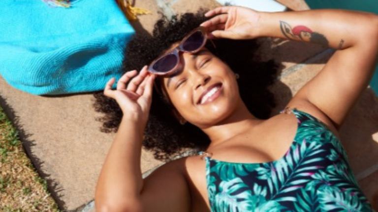 Black girl laying by the pool